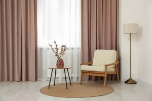 brown curtains hanging with white chair