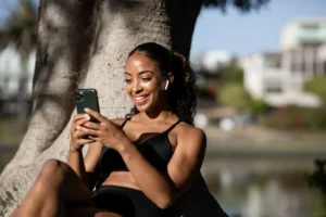 girl laughing while scrolling phone