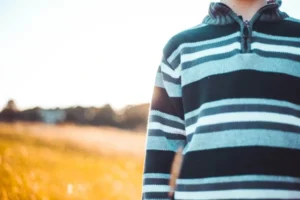 boy standing outside on sunny day