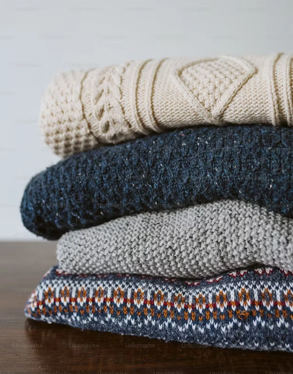 Sweaters folded on table